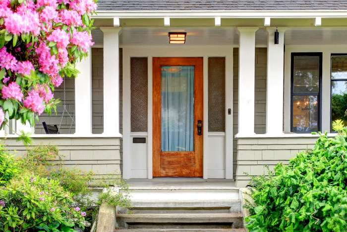 Beautiful front porch with four half columns on decorative knee walls
